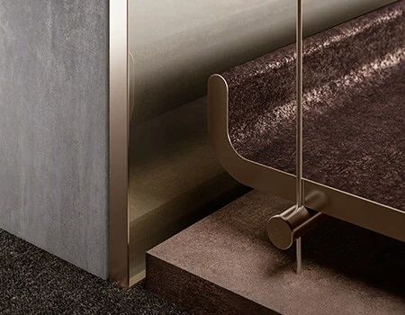 Architectural film finishes — textured stone, brushed metal and leather-grain surfaces meeting at an interior detail