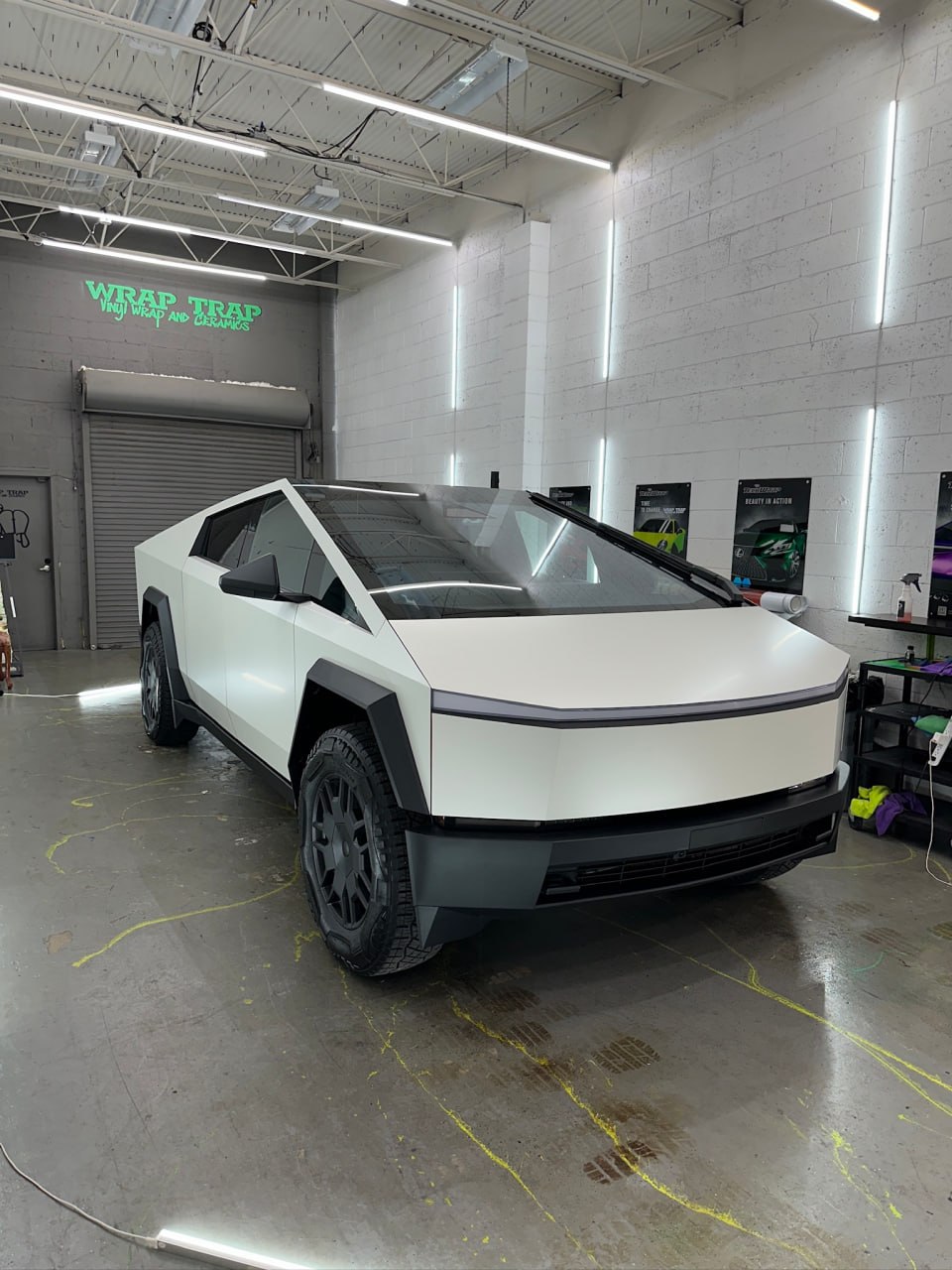 Tesla Cybertruck wrapped in 3M Satin Pearl White inside the Wrap Trap shop